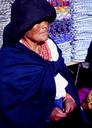 Great example of the local clothing -- the thick, layered necklace, the heavy scarf on the head, the skirt and the poncho -- all in white and blue.